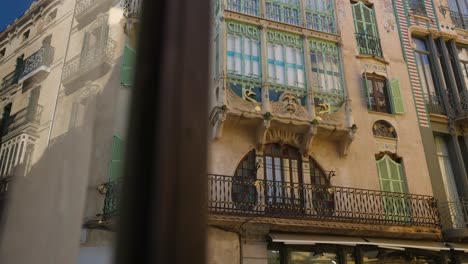 Arquitectura-Española-Ornamentada-En-Exhibición-En-Palma,-Mallorca,-Con-Fachadas-De-Edificios-Coloridos-Con-Balcones-Y-Contraventanas