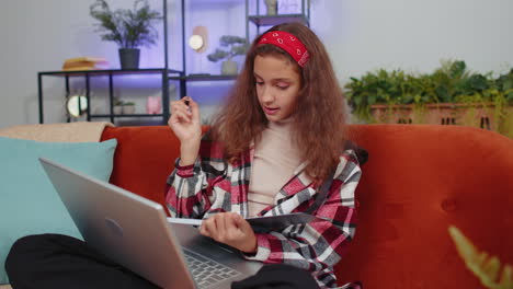 Child-girl-student-study-at-home-on-laptop-computer-making-conference-video-call-talking-to-webcam