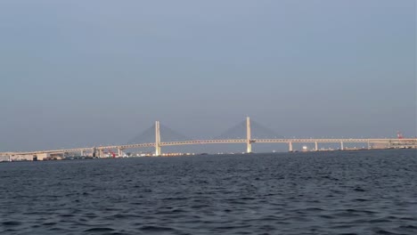 Bridge-over-wide-water-with-a-clear-sky