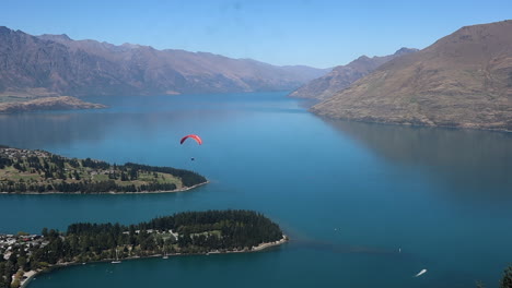 Paragliding-flying-over-a-lake-in-New-Zealand-from-the-Air