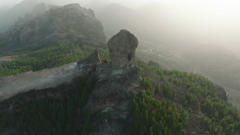 Fantastic-aerial-view-in-orbit-during-the-sunset-of-Roque-Nublo-on-the-island-of-Gran-Canaria,-Spain