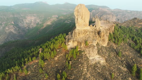 Wonderful-aerial-view-in-orbit-during-the-sunset-of-Roque-Nublo-on-the-island-of-Gran-Canaria-with-beautiful-colors,-Spain