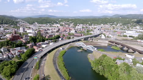 Downtown-Cumberland,-Maryland-with-freeway-traffic-with-drone-video-pan-right-to-left