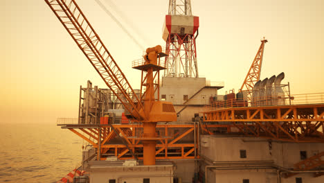 Fast-fly-through-shot-of-offshore-drilling-rig-extracting-crude-oil-on-the-open-sea-or-ocean.-Orange-sunset-sky-in-the-background.-Illustration-for-power-industry,-technology,--refinery-4k-HD