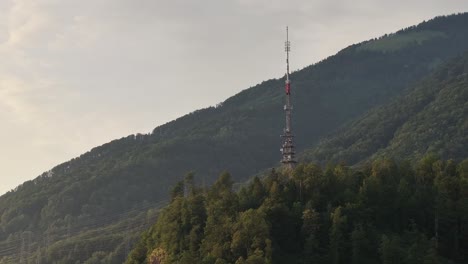 Aerial-view-capturing-the-TV-tower-on-the-hill-area-of-Glarus-Nord,-Switzerland