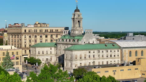 Portland,-Maine-City-Hall-in-front-of-clear-blue-sky,-zoom-out-view-reveals-lush-green-trees