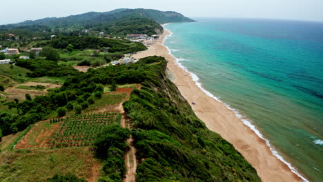 Aerial-drone-shot-over-the-long-stretching-empty-sandy-beach-in-Corfu-in-Greece