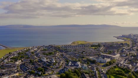 Aerial-pan-shot-of-Claddagh,-Galway-Bay,-and-the-Burren-on-a-sunny-day