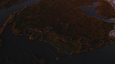 Aerial-overview-of-swamp-estuary-marshland-and-beaches-in-Chincoteague-Virginia-at-sunset