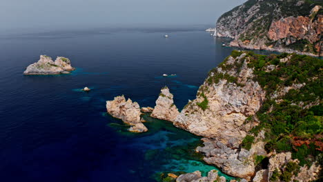 Aerial-drone-view-of-the-picturesque-rocky-coastline-of-Paleokastritsa-in-Corfu,-Greece