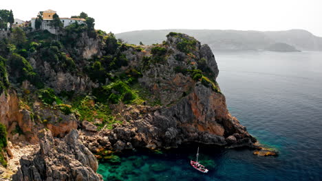 Aerial-drone-shot-over-the-picturesque-rocky-coastline-of-Paleokastritsa-bay-in-Corfu,-Greece