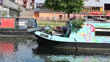 Canal-Boat-going-past-No90-Hackney-Wick,-London,-United-Kingdom