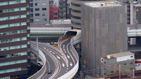 Close-up-view-of-a-highway-running-through-a-building-in-Osaka,-Japan