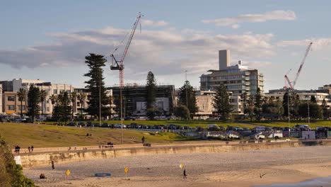 Close-shot-of-construction-cranes-over-Bondi-Beach-at-sunrise