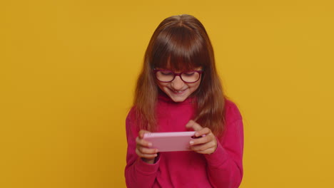 Worried-excited-child-girl-playing-racing-or-shooter-simulator-gadget-app-video-games-on-smartphone