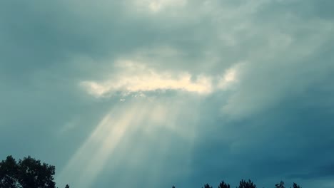 Atemberaubende-Sonnenstrahlen-Durchdringen-Die-Wolken-Vor-Einem-Strahlend-Blauen-Himmel,-Ruhige-Aussicht