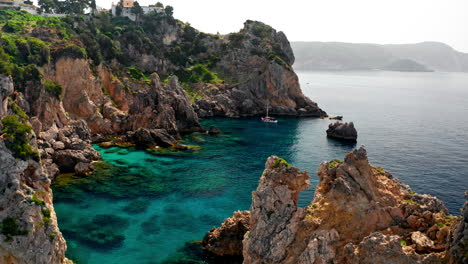 Aerial-drone-shot-over-the-picturesque-rocky-coastline-of-Paleokastritsa-bay-in-Corfu,-Greece