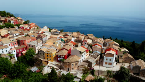 Aerial-drone-shot-over-old-Greek-mountain-village-of-Lakones-in-Corfu-surrounded-in-green-lush-vegetation