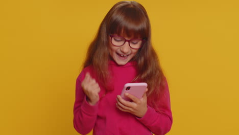 Child-girl-kid-use-mobile-smartphone-browsing-say-Wow-yes-found-out-great-win-good-news-celebrate