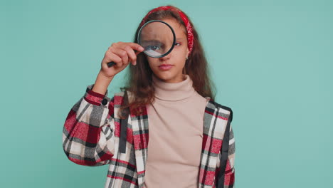 Investigator-teenager-child-girl-kid-holding-magnifying-glass-near-face,-big-eye-searching-analysing