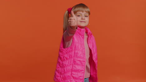 Toddler-girl-raises-thumbs-up-agrees-or-gives-positive-reply-recommends-advertisement-likes-good