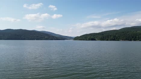 Landscape-of-majestic-Zywiec-lake-in-Beskid-mountains-during-a-beautiful-summer-day---aerial-view-4K