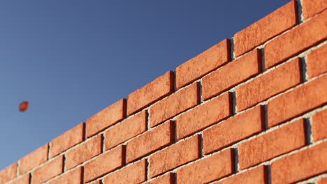 Brick-wall-made-out-of-clay-bricks-being-build-in-the-endless-animation-loop.-Filled-with-the-light-grey-cement.-Horizontal-camera-movement-at-the-completely-cloudless-blue-sky.-Loopable.