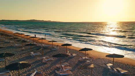 Aerial-drone-shot-of-a-tropical-beach-at-sunset