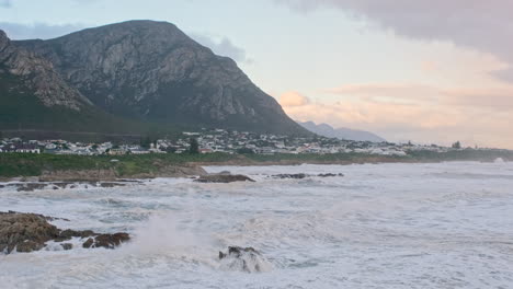 Frothing-ocean-waves-rolling-towards-rocky-Hermanus-coastline-in-Voëlklip