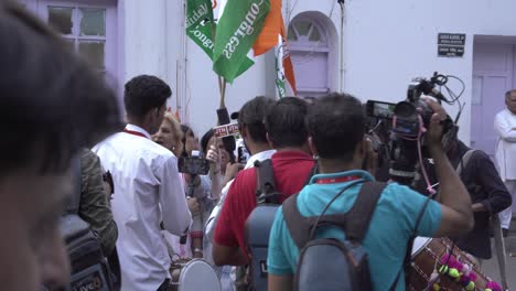 Indian-media-video-journalists-reporting-live-with-people-celebrating-Congress-victory-at-18th-Lok-Sabha-elections