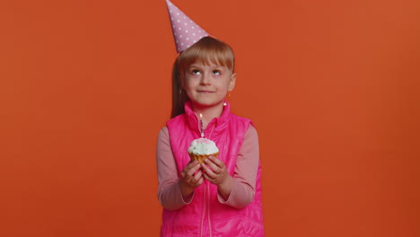 Happy-toddler-children-girl-celebrating-birthday-anniversary-party,-blowing-candle-on-small-cake