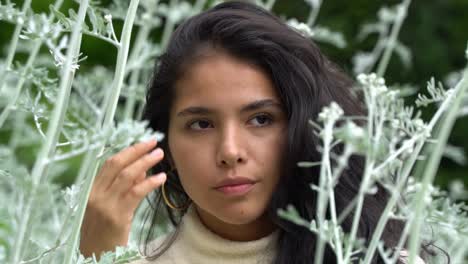 Attractive-woman-posing,-smiling-and-adjusting-hair,-portrait-view