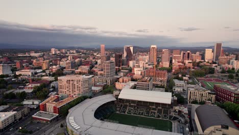 A-drone-shot-over-downtown-Portland,-Oregon,-reveals-a-vibrant-cityscape-with-skyscrapers,-bridges,-and-bustling-streets,-capturing-the-dynamic-energy-and-scenic-beauty-of-the-urban-environment