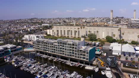 Aerial-close-up-panning-shot-of-the-leasing-apartments-at-King-Harbor-Marina-in-Redondo-Beach,-California