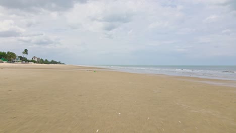 Cha-Am-Beach-in-Thailand-with-Low-Flying-Drone-Over-Water-and-Sand