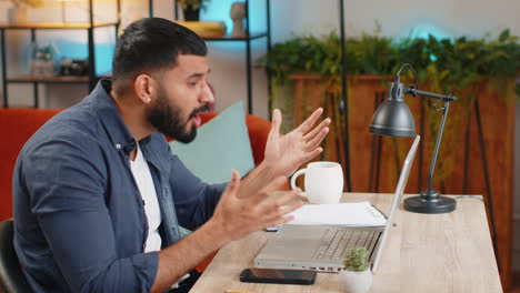 Angry-furious-Indian-man-freelancer-using-laptop-working-at-home-office-nervous-breakdown-at-work