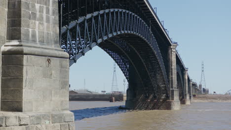 Slow-motion-shot-of-the-Eads-Bridge-over-the-Mississippi-River-in-Downtown-St