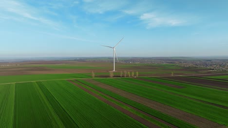 Wind-turbine-in-a-green-field-on-a-sunny-day-with-a-blue-sky