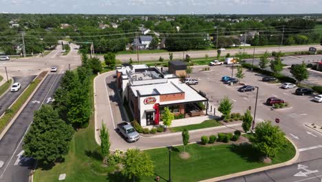 Drone-descends-dolly-to-Raising-Cane's-as-silver-truck-leaves-drive-thru