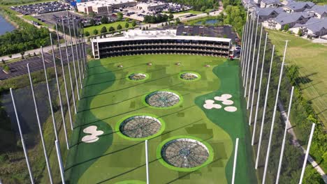 Establishing-Drone-Shot-Above-TopGolf-Driving-Range-in-American-Suburb