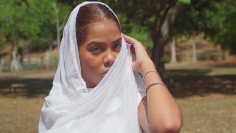 In-Trinidad's-Caribbean-Botanical-Gardens,-a-young-girl-dressed-in-white-delights-in-the-sunshine