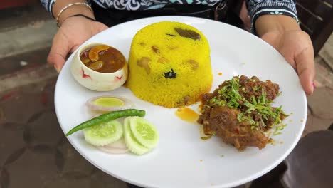 Plate-full-of-Bengali-style-preparation-of-Basanti-Pulao-and-Mutton-Kossa-with-salad-and-chutney