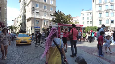 Pedestrian-area-in-Istanbul,-Turkey,-featuring-a-girl-with-pink-braids-in-slow-motion