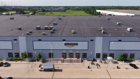 Aerial-dolly-to-Amazon-distribution-warehouse-with-midwestern-magical-sky-and-green-grass