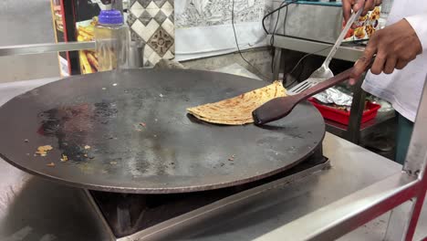 A-man-preparing-lacha-paratha-at-a-shop-in-India