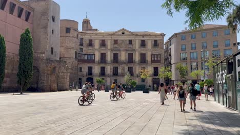 Sunny-day-in-a-historic-plaza-in-Barcelona-with-tourists-walking-and-exploring