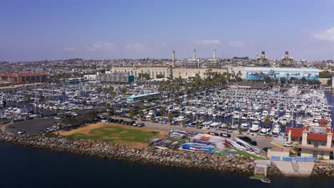 Aerial-low-panning-shot-of-the-boat-landing-at-King-Harbor-Marina-in-Redondo-Beach,-California