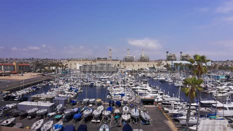 Aerial-rising-reverse-pullback-shot-of-the-King-Harbor-Yacht-Club-in-Redondo-Beach,-California