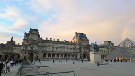 Panoramic-view-of-the-Louvre-Palace-and-Pyramid-as-the-art-museum-entrance-covered-with-rainbow-in-Paris,-France