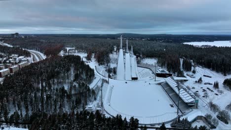 Aerial-view-around-the-Salpausselka-ski-jump-center,-winter-in-Lahti,-Finland